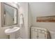 Small bathroom with pedestal sink, mirror, and cabinet at 311 Calm Water Way, Summerville, SC 29486