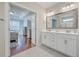 Main bathroom with double vanity, large mirror, and view of bedroom at 311 Calm Water Way, Summerville, SC 29486