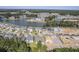 An aerial view of a beautiful community with houses surrounding a lake. New construction is also visible at 311 Calm Water Way, Summerville, SC 29486