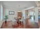 Formal dining room with hardwood floors and a wooden table with seating for four at 311 Calm Water Way, Summerville, SC 29486