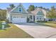 House exterior with white garage door and landscaping at 311 Calm Water Way, Summerville, SC 29486
