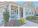 Inviting front porch with teal chairs and landscaping at 311 Calm Water Way, Summerville, SC 29486