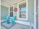 Inviting front porch with teal chairs and fall decor at 311 Calm Water Way, Summerville, SC 29486