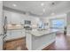 Island kitchen with granite countertops, stainless steel appliances, and hardwood floors at 311 Calm Water Way, Summerville, SC 29486