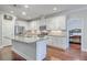 Modern kitchen with white cabinets, granite countertops, and stainless steel appliances at 311 Calm Water Way, Summerville, SC 29486