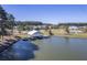 Aerial view of a lakefront community with houses, walking paths, and a dock at 311 Calm Water Way, Summerville, SC 29486