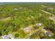 Aerial view of a modern farmhouse with lush landscaping and surrounding greenery at 3324 Westphal Dr, Johns Island, SC 29455