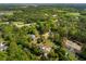 Aerial image of a home and neighboring properties in a lush, green, wooded neighborhood at 3324 Westphal Dr, Johns Island, SC 29455