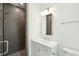 Contemporary bathroom boasts glass shower with dark tile and vanity with ample lighting at 3324 Westphal Dr, Johns Island, SC 29455