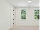 Bedroom boasts natural light from windows framing lush green trees at 3324 Westphal Dr, Johns Island, SC 29455