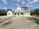 Two story white farmhouse with gray roof and a large front porch at 3324 Westphal Dr, Johns Island, SC 29455