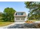 Charming two-story home features a white exterior with a two-car garage and a well-manicured lawn at 3324 Westphal Dr, Johns Island, SC 29455