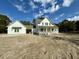 Two-story farmhouse with white siding, gray roof, and a front porch at 3324 Westphal Dr, Johns Island, SC 29455