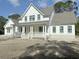 Two-story farmhouse with white siding, gray roof, and a front porch at 3324 Westphal Dr, Johns Island, SC 29455