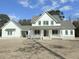 Two-story farmhouse with white siding, gray roof, and a front porch at 3324 Westphal Dr, Johns Island, SC 29455