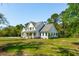 Charming two-story farmhouse featuring a welcoming front porch and well-manicured lawn at 3324 Westphal Dr, Johns Island, SC 29455