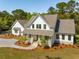 Charming two-story modern farmhouse with a welcoming front porch and a well-maintained yard at 3324 Westphal Dr, Johns Island, SC 29455