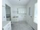 Bright laundry room with white cabinets and built-in shelves at 3324 Westphal Dr, Johns Island, SC 29455