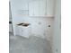 Unfinished laundry room with white cabinets and shelving at 3324 Westphal Dr, Johns Island, SC 29455