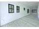 Spacious front porch with whitewashed wood flooring and black framed windows at 3324 Westphal Dr, Johns Island, SC 29455