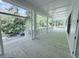 Screened porch with wooden floors and white railings at 3324 Westphal Dr, Johns Island, SC 29455