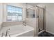 Relaxing bathroom with soaking tub, shower, and tile surround at 346 Bradley Bend Drive, Moncks Corner, SC 29461