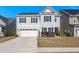 Two-story house with gray siding, a white garage door, and landscaping at 346 Bradley Bend Drive, Moncks Corner, SC 29461