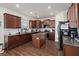 Modern kitchen with dark wood cabinets and granite countertops at 346 Bradley Bend Drive, Moncks Corner, SC 29461