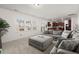 Spacious living room with grey sectional sofa and large windows at 346 Bradley Bend Drive, Moncks Corner, SC 29461