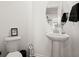 Clean powder room with a pedestal sink, toilet, and round mirror at 346 Bradley Bend Drive, Moncks Corner, SC 29461