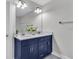 Bathroom with a navy blue double vanity and granite countertop at 4587 Summey St, North Charleston, SC 29405