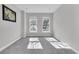 Bright bedroom with carpet flooring and two large windows at 4587 Summey St, North Charleston, SC 29405