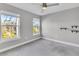Spacious bedroom with grey carpet, ceiling fan and two windows at 4587 Summey St, North Charleston, SC 29405