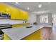 Modern kitchen with yellow cabinets, granite countertops and island at 4587 Summey St, North Charleston, SC 29405