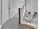 Wooden staircase with carpeted hallway and white door at 4587 Summey St, North Charleston, SC 29405
