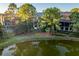 Luxury homes surround a peaceful pond with a wooden footbridge at 515 Claret Way, Kiawah Island, SC 29455