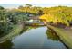 Picturesque wooden bridge over a tranquil pond in a lush setting at 515 Claret Way, Kiawah Island, SC 29455