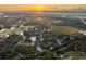 Aerial view of a neighborhood at sunset, showcasing homes and waterways at 515 Claret Way, Kiawah Island, SC 29455