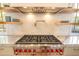 Stainless steel gas cooktop with red knobs and marble counter at 515 Claret Way, Kiawah Island, SC 29455