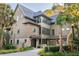 Two story home with metal roof, landscaping, and large windows at 515 Claret Way, Kiawah Island, SC 29455