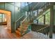 Elegant wooden staircase with green wall and natural light at 515 Claret Way, Kiawah Island, SC 29455
