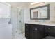 Bathroom with a walk-in shower, vanity with granite countertop, and a stackable washer/dryer at 53 Hasell Street St # H, Charleston, SC 29401