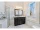 Bright bathroom with a walk-in shower, vanity with granite countertop and large window at 53 Hasell Street St # H, Charleston, SC 29401