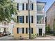 Three story yellow house with black shutters, white columns and a gated courtyard at 53 Hasell Street St # H, Charleston, SC 29401