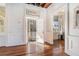 Bright interior with hardwood floors, exposed beams, and access to a private balcony at 53 Hasell Street St # H, Charleston, SC 29401