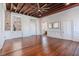 Spacious living area with hardwood floors, exposed beams, and large windows at 53 Hasell Street St # H, Charleston, SC 29401