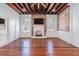 Living room with hardwood floors, exposed beams, fireplace and a TV at 53 Hasell Street St # H, Charleston, SC 29401