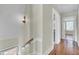 Upstairs hallway with hardwood floors and neutral walls at 600 S Laurel St, Summerville, SC 29483