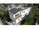 Three-story home with rooftop deck, balconies, and surrounding trees at 615 W Beach Ct, Folly Beach, SC 29439