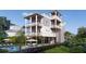 Stunning three-story home with multiple balconies and a refreshing backyard pool, perfect for outdoor living at 615 W Beach Ct, Folly Beach, SC 29439